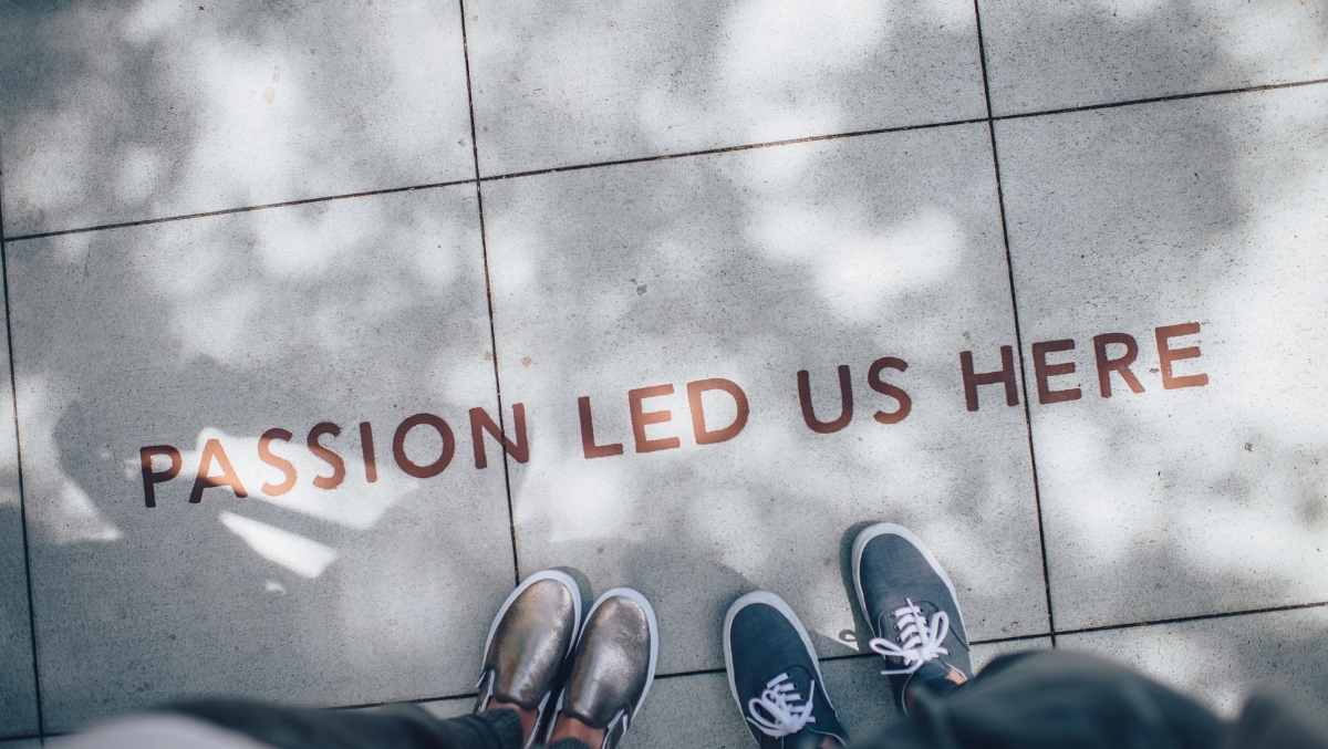 "Passion Led Us Here" painted on a sidewalk